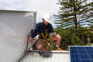 man testing solar panel