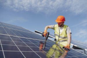 man installing solar