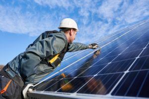 man installing solar