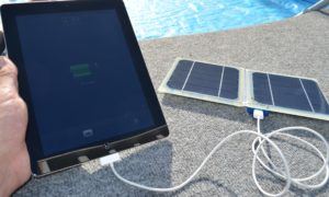 ipad being charged by solar panel